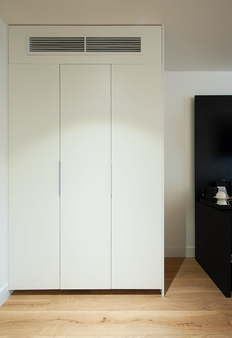 White closet to conceal air conditioning systems made of Unilin Panels material 